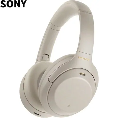 Cream over-ear headphones lying flat on white, with the maker name set in large black letters in the top corner of the frame.