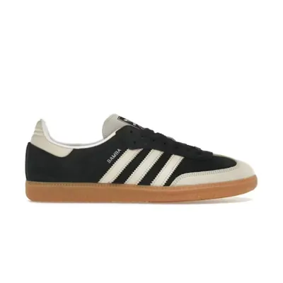 A black suede sneaker, three white stripes along the side, a cream heel patch and toe, and a gum rubber sole, shot side on against white.